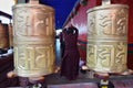 Buddhist and the prayer wheels. Mantra Om mani padme hum in Sanskrit written on them.