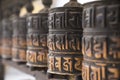 Buddhist prayer wheels in row Royalty Free Stock Photo