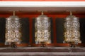 Buddhist prayer wheels in Tibetan monastery with written mantra. Himalayan village, Nepal Royalty Free Stock Photo