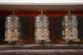 Buddhist prayer wheels in Tibetan monastery with written mantra. Himalayan village, Nepal Royalty Free Stock Photo