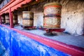 Buddhist prayer wheels in Tibetan monastery with written mantra. India, Himalaya, Ladakh Royalty Free Stock Photo