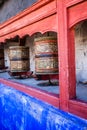 Buddhist prayer wheels in Tibetan monastery with written mantra. India, Himalaya, Ladakh Royalty Free Stock Photo