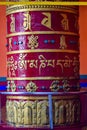 Buddhist prayer wheels in Tibetan monastery with written mantra. India, Himalaya, Ladakh, Buddhist prayer drums with close-up mant Royalty Free Stock Photo