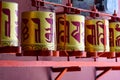 Buddhist prayer wheels in Tibetan monastery with written mantra. India, Himalaya, Ladakh, Buddhist prayer drums with close-up mant Royalty Free Stock Photo