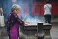 Buddhist prayers burning incense Royalty Free Stock Photo