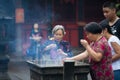 Buddhist prayers burning incense Royalty Free Stock Photo