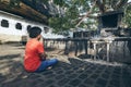 Buddhist praying against cave temple