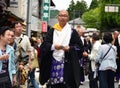 Buddhist priest distributing good luck charms during Aoba festival