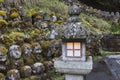 Buddhist rakan stone statues and a stone lantern at the Otagi Nenbutsu-ji temple in Arashiyama, Kyoto, Japan Royalty Free Stock Photo