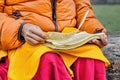 A Buddhist reading ancient scrolls in Sarnath where Gautama Buddha first taught the Dharma.