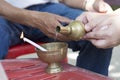 Buddhist's man and woman hand ibation grail pouring water