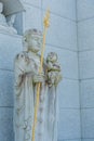 Buddhist statue holding a golden staff and praying baby