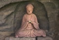 Buddhist statue of the monk YÃÂka Genkaku in a cavity of Mount Nokogiri quarry. Royalty Free Stock Photo