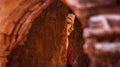 Buddhist statue in red tones through an arch door in Bagan, Myanmar