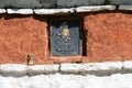 A Buddhist statuette was placed on the wall of a temple near Thimphu (Bhutan).