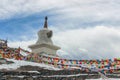 Buddhist Stupa with prayer flags on snow mountain Royalty Free Stock Photo