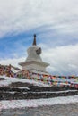 Buddhist Stupa with prayer flags on snow mountain Royalty Free Stock Photo