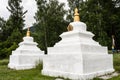 Buddhist stupas in the monastery. mountain stupa. Prayer flags with stupas - the pass.