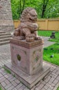 The Buddhist temple Datsan Gunzechoinei. The chinese guardian lion Foo Dog near the entrance. Royalty Free Stock Photo