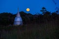 Buddhist temple and full moon