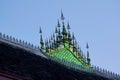 Buddhist temple of Wat Wisunarat in Luang Prabang, Laos. Architectural detail of the glass mosaic ornament on the rooftop. Royalty Free Stock Photo