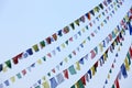 Buddhist tibetan prayer flags waving in the wind against blue sk Royalty Free Stock Photo