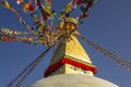 Buddhist Tibetan stupa Bodnath in Kathmandu with multicolored prayer flags against a clean blue sky and the moon Royalty Free Stock Photo