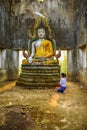 Buddhist tourist woman worshiping old Buddha image