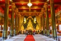 Buddhist tourists worshiping golden Buddha image in Buddhist church