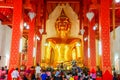 Buddhist tourists worshiping golden Buddha image