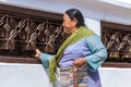 Buddhist Woman Turning Prayer Wheels