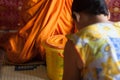 Buddhist women are offering items to the monks.