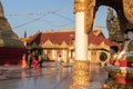 Buddhist women walking inside the U Zina Pagoda. Evening, sunset time. They wear traditional longyi and long dark hair. Mawlamyine