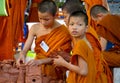 Buddhist young monk in Thailand temple wat doing handcrafts