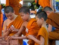 Buddhist young monks doing hand crafts in the temple yard