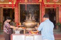Buddhists lighting up candles and joss sticks in Chinese temple