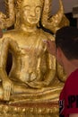 Buddhists make merit ,Gilding gold leaf to Buddha for worship. ,