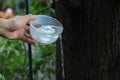 Buddhists make merit,Pouring water from the bottle into the cup, after a good deed and share the wealth to Buddhism.