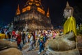 Buddhists people walking with lighted candles in hand around a ancient temple