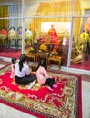 Buddhists pray near embalmed monk, inside Wat Mangkon Kamalawat, Chinatown, Bangkok Royalty Free Stock Photo