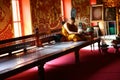 Buddist monk reading magazine