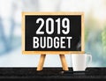 2019 budget on blackboard with easel on black marble table with Royalty Free Stock Photo