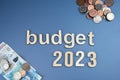 Budget 2023 on blue background, British coins and notes Royalty Free Stock Photo