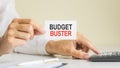 budget buster, message on business card shown by a woman