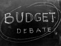 Budget Debate Handwritten on Blackboard - Stock image