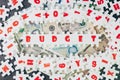 Budget idea, abundance white puzzle jigsaw with alphabets combine word BUDGET and other letter pieces around on banknotes and dar Royalty Free Stock Photo