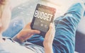 Budget with man using a tablet Royalty Free Stock Photo