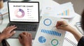 Budget Planning. Analyzing financial data with pie charts and graphs on a laptop. Royalty Free Stock Photo
