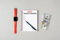 2022 budget planning banner with copy space. Notepad, pen, stack of money and a cup of black coffee isolated on gray Royalty Free Stock Photo