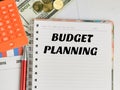 Budget Planning written on note book with calculator,pen,money and chart. Royalty Free Stock Photo